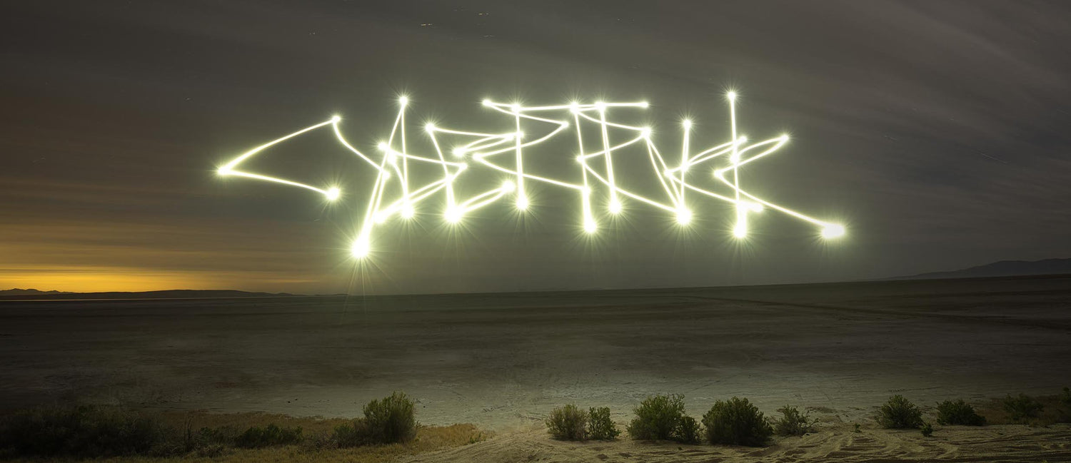 The Tesla Cybertruck graffiti logo written as light painting in the night landscape.